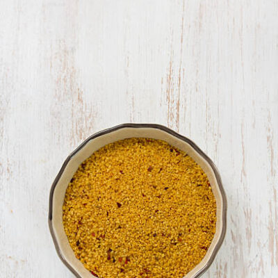Couscous in dish on white background